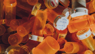 a pile of pill orange pill bottles