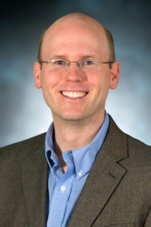 Image of Matt Johnson, white man, thinning hair, glasses and a blue shirt
