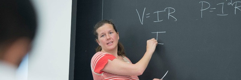 Professor Libby Bucholz of Duke University teaches an undergraduate class at a chalkboard 