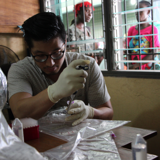 Daniel Joh, an MD-PhD student in BME, prepares serum samples during a field test at the Redemption Clinic in Monrovia, Liberia