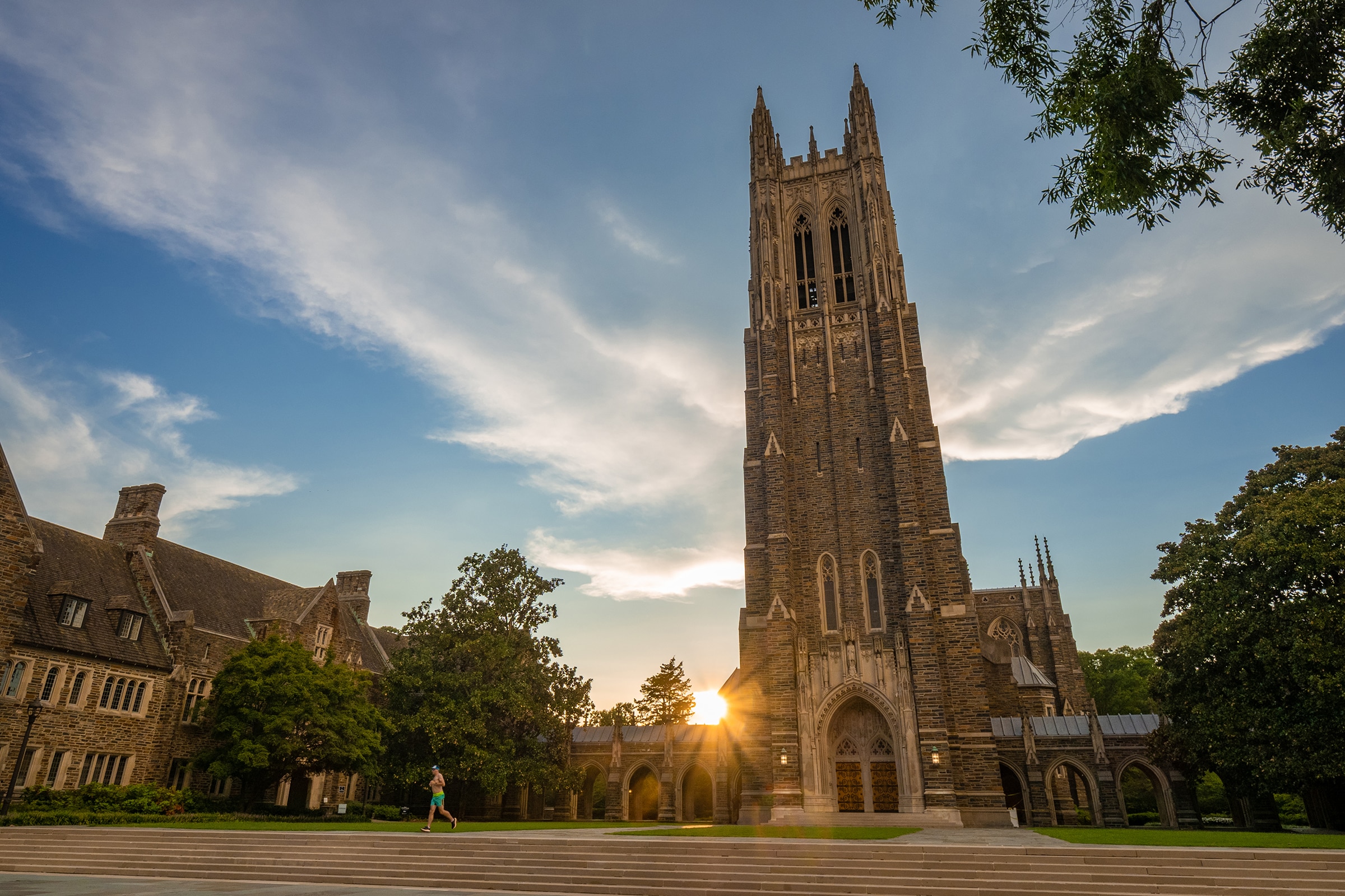 Sunset behind a Gothic collegiate chapel