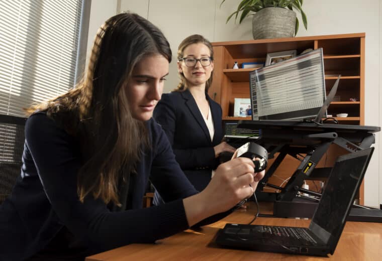 Jessilyn Dunn and one of her graduate students study the data gathered from a smartwatch