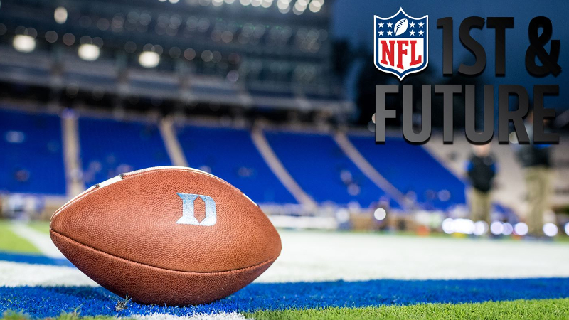 A Duke football on the Duke football field with the NFL logo