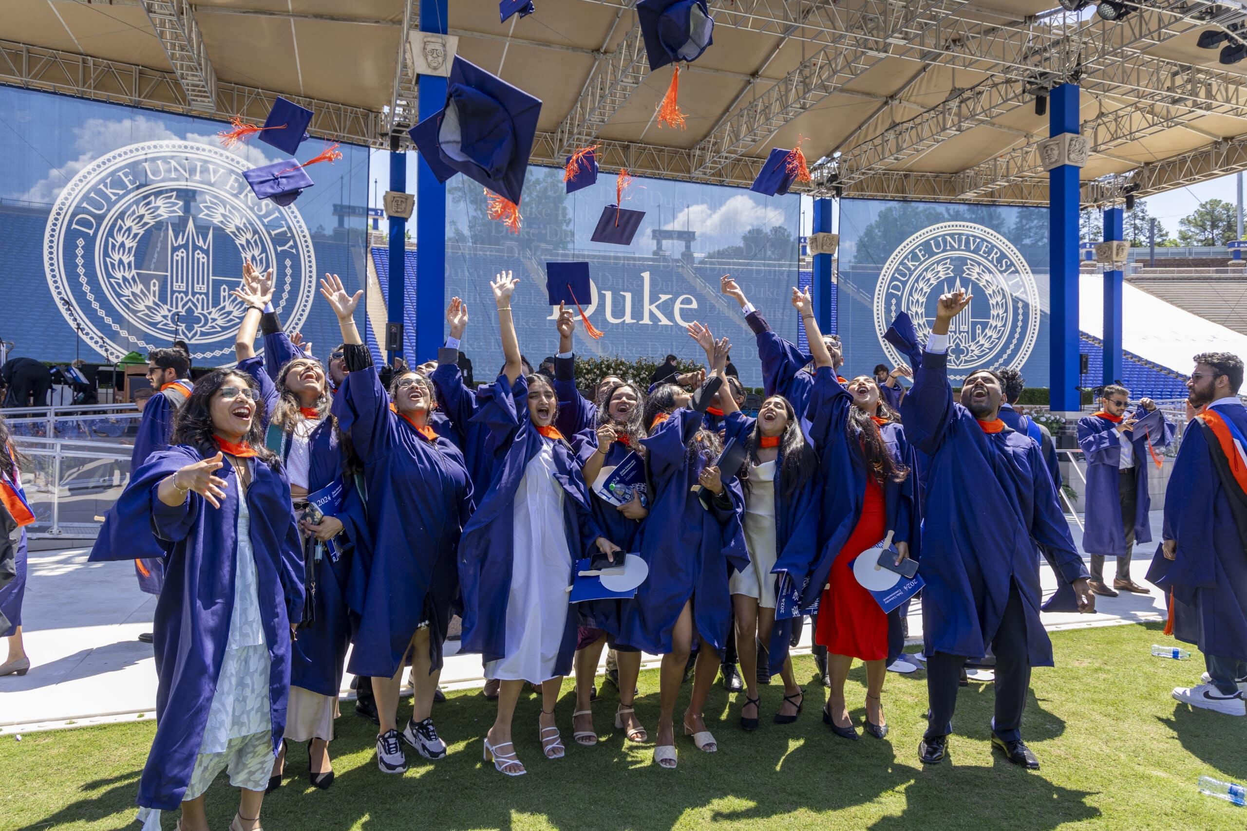 Duke Engineering students toss caps in the air at graduation